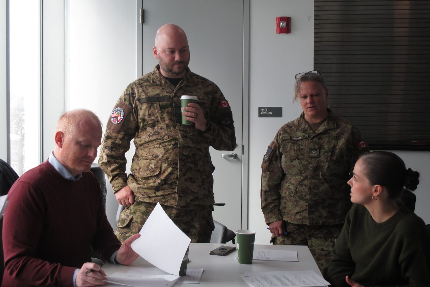 Allied officers and Icelandic representatives working through injects during the Polar Frontlines wargame.